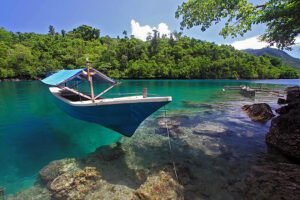 Halmahera Shore With A Boat And Smaller Boat Visible