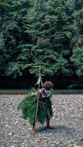 Traditional Papua People of Raja Ampat in the Blue River